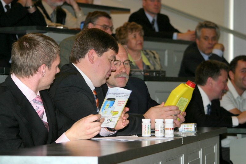Latvijas Universitātes zinātnieki informē LR Ministru prezidentu Aigaru Kalvīti par pētījumiem dzīvības zinātnes nozarēs. Aigars Kalvītis (2.no kreisās) un LU rektors Ivars Lācis aplūko preparātu augsnes bagātināšanai 'Kūdras eliksīrs - 1'.