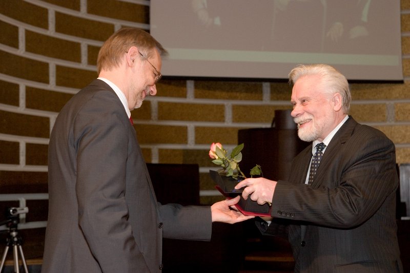 LU darbinieku sapulce. LU Gada balvas par sasniegumiem zinātnē pasniegšana. LU rektors Mārcis Auziņš pasniedz balvu prof. Jānim Bārzdiņam.