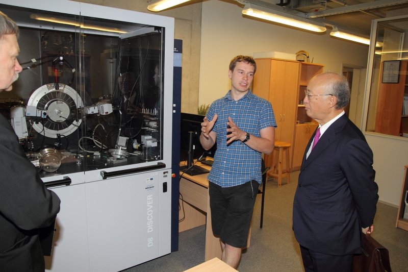 Starptautiskās atomenerģijas aģentūras ģenerāldirektora Jukijas Amano (Yukiya Amano) vizīte Latvijas Universitātes Dabaszinātņu akadēmiskajā centrā. Pulvera rentgendifraktometrs (PXRD), doktorants Agris Bērziņš un Jukija Amano.
