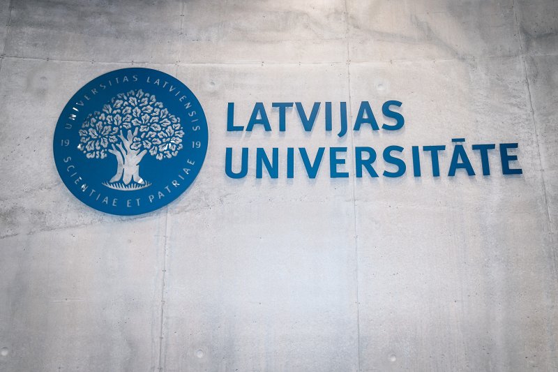 Latvijas universitātes logo uz sienas auditorijā Alfa LU Zinātņu mājā. null